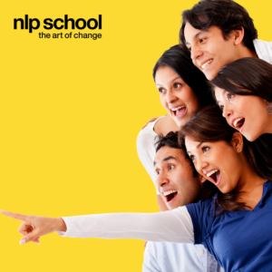 Group of young adults pointing at something and smiling and laughing. NLP School logo in the top left corner